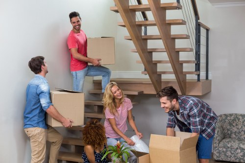 Team preparing moving equipment safely before a removal job
