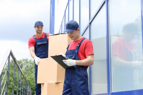 Removal staff handling furniture in a Tobelgium business property