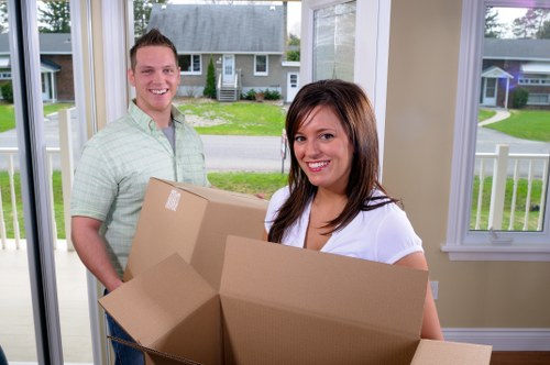 Movers handling belongings during a scheduled removal service